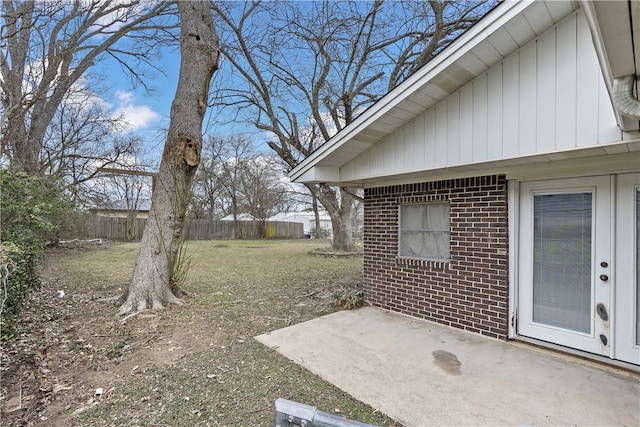 view of yard featuring fence and a patio