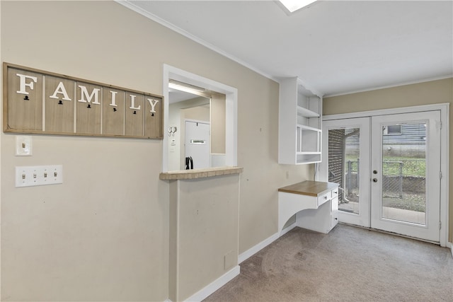 interior space with ornamental molding, french doors, light carpet, and baseboards