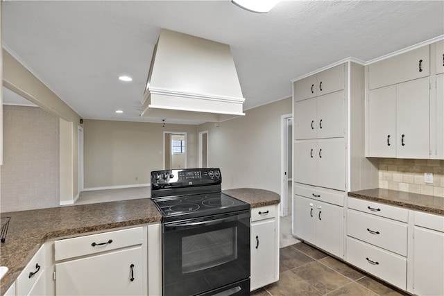 kitchen with dark countertops, white cabinetry, custom range hood, and black / electric stove