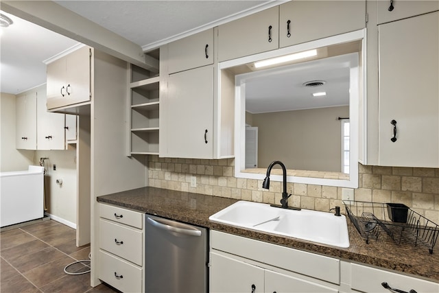 kitchen with a sink, white cabinets, and stainless steel dishwasher