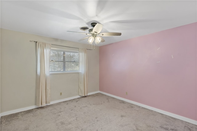 spare room with light carpet, visible vents, and baseboards