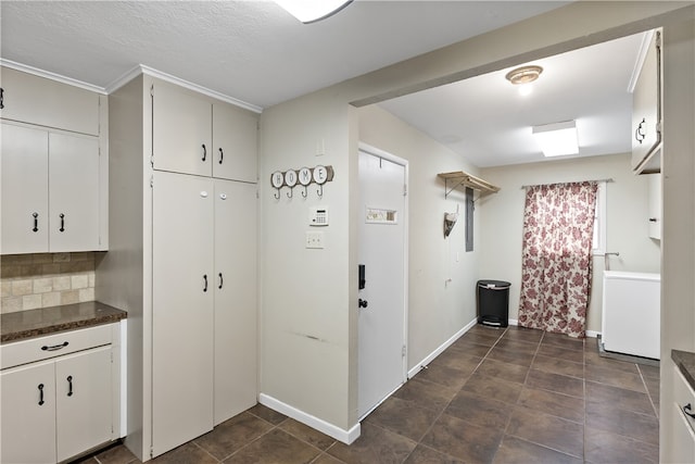 laundry room with baseboards