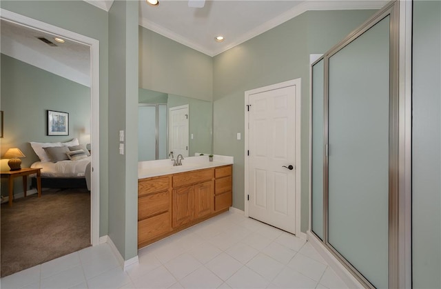 bathroom with vanity, a shower with door, and ornamental molding