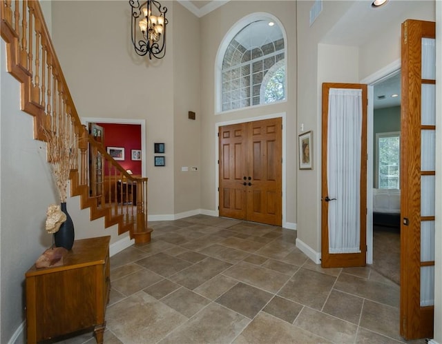 entryway featuring a chandelier and a towering ceiling