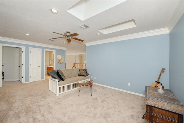 living area featuring a skylight, crown molding, and light carpet