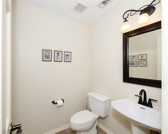 bathroom with tile patterned floors, toilet, and sink