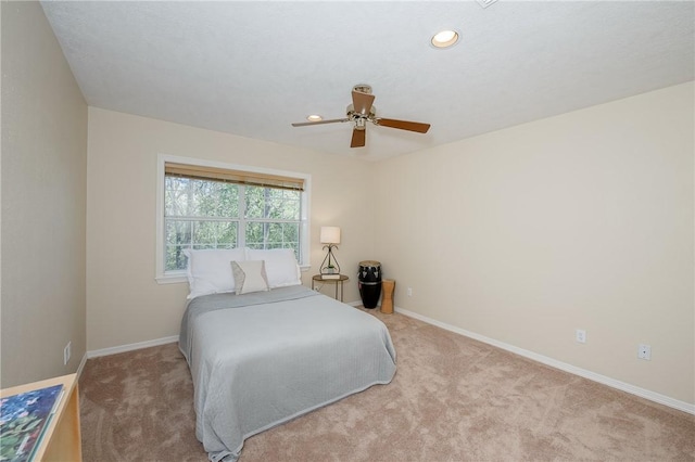 bedroom with light carpet and ceiling fan