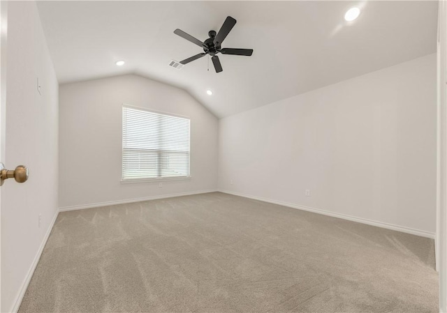 carpeted spare room with ceiling fan and lofted ceiling