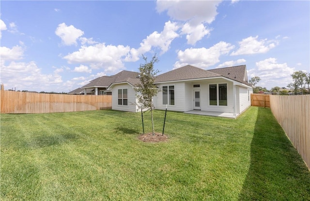 rear view of house featuring a patio area and a yard