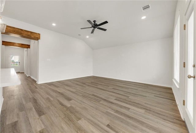 spare room with light hardwood / wood-style floors, vaulted ceiling, and ceiling fan