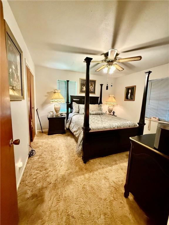 312 S 5th St, Crockett, TX 75835 - bedroom featuring light colored carpet and ceiling fan