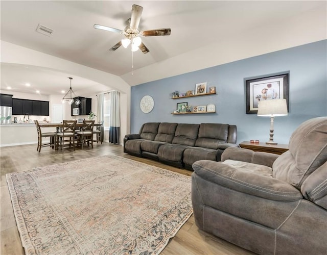 living room featuring light wood-type flooring and ceiling fan