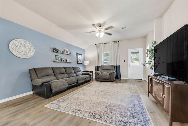 living room featuring light hardwood / wood-style flooring, ceiling fan, and lofted ceiling