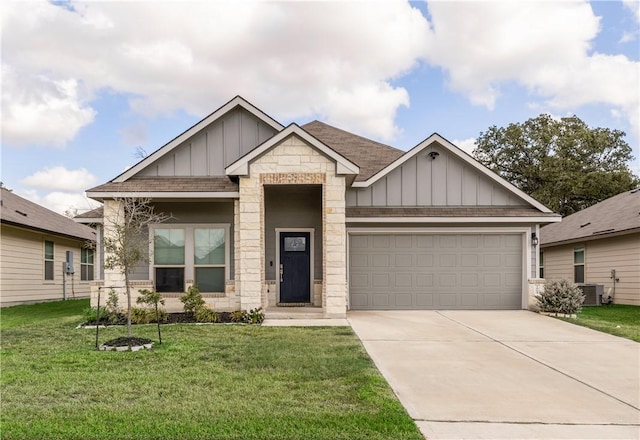 craftsman house with cooling unit, a front lawn, and a garage