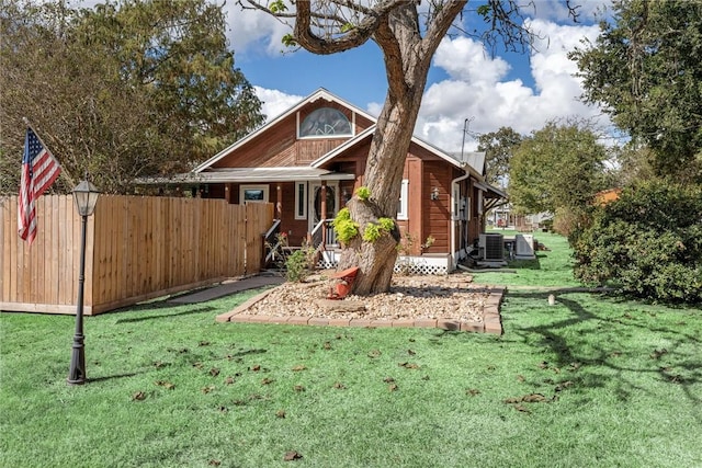 exterior space featuring a yard and central AC