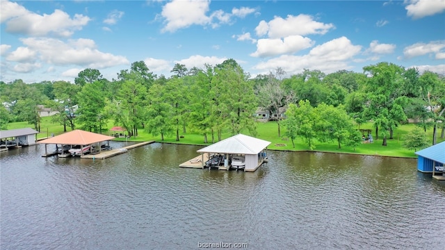 view of dock with a yard and a water view