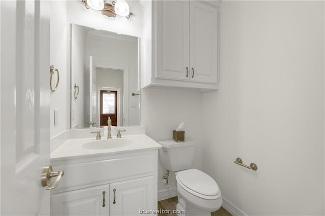 bathroom featuring vanity and toilet