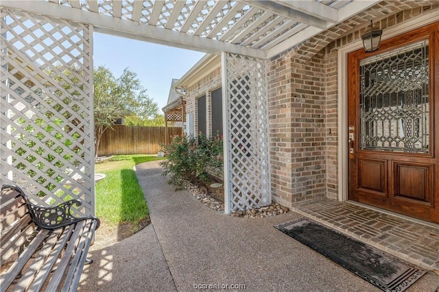 entrance to property featuring a pergola