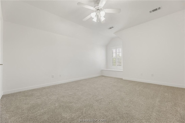 unfurnished room featuring ceiling fan, carpet floors, and vaulted ceiling