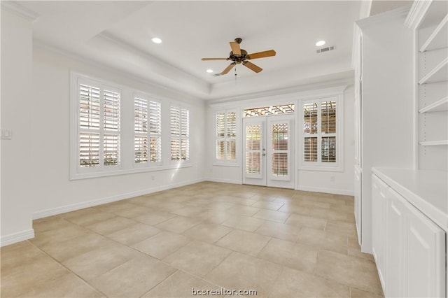 unfurnished room with light tile patterned floors, plenty of natural light, crown molding, and ceiling fan