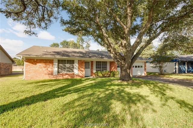 ranch-style house featuring a garage and a front yard