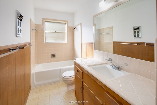 full bathroom featuring tiled shower / bath combo, toilet, and vanity