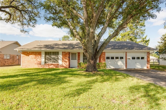 ranch-style house featuring a front lawn and a garage