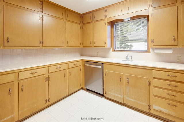 kitchen featuring dishwasher, decorative backsplash, and sink