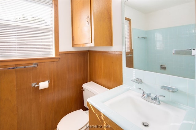 bathroom featuring plenty of natural light, toilet, and vanity