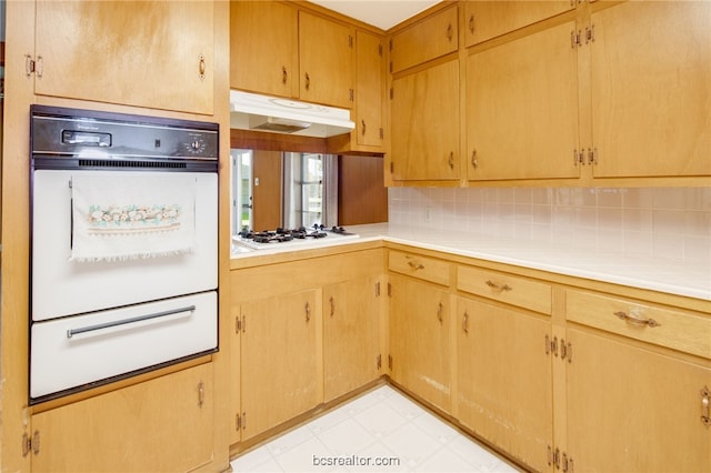 kitchen with tasteful backsplash and white gas stovetop