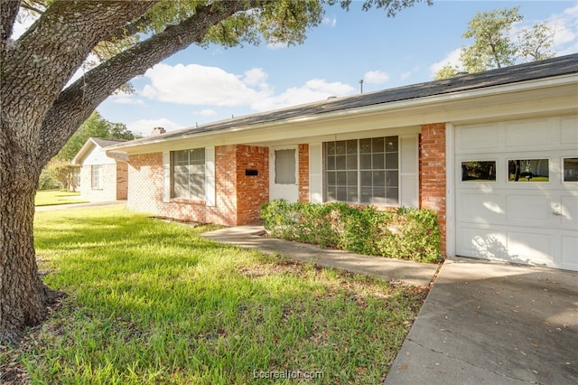 ranch-style house with a front yard and a garage