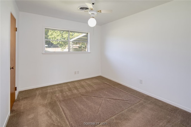 unfurnished room with ceiling fan and carpet