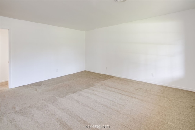 empty room with light colored carpet