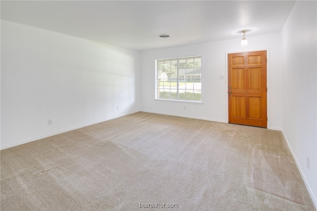 unfurnished room with light colored carpet