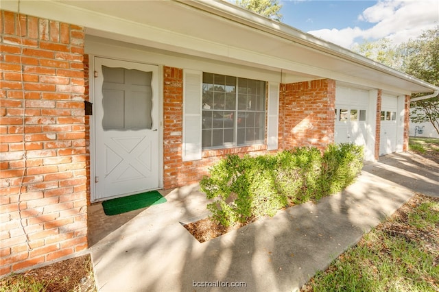 doorway to property with a garage