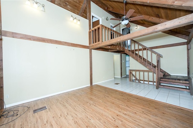 interior space with tile patterned floors, ceiling fan, and wood ceiling