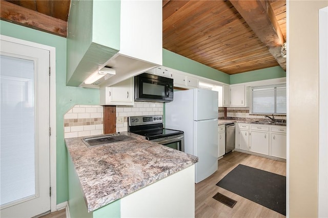 kitchen featuring decorative backsplash, kitchen peninsula, stainless steel appliances, island range hood, and white cabinetry