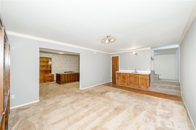 unfurnished living room featuring sink, light colored carpet, and ornamental molding