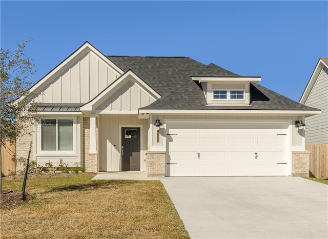 view of front of house with a front yard, central AC, and a garage