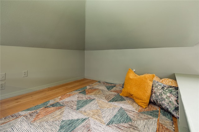 1015 E 24th St, Bryan, TX 77803 - bedroom with wood finished floors, lofted ceiling, and baseboards