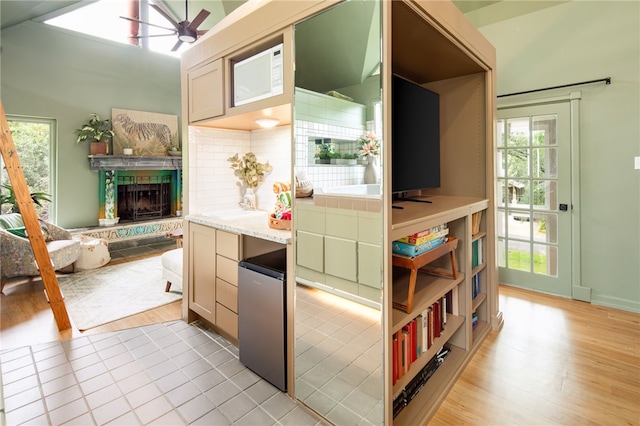 1015 E 24th St, Bryan, TX 77803 - kitchen featuring refrigerator, healthy amount of natural light, a ceiling fan, and tasteful backsplash