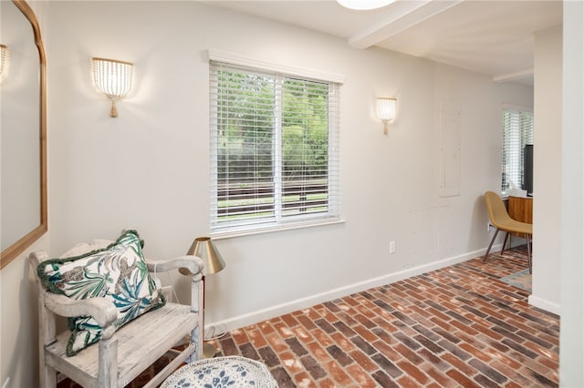 1015 E 24th St, Bryan, TX 77803 - sitting room featuring baseboards, brick flooring, and beamed ceiling