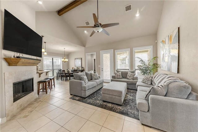 living room with high vaulted ceiling, light tile patterned flooring, visible vents, a ceiling fan, and beam ceiling