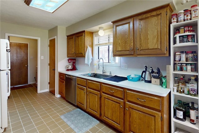 kitchen featuring brown cabinets, a sink, freestanding refrigerator, light countertops, and dishwasher