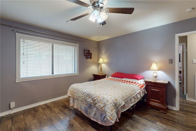 bedroom featuring dark wood finished floors, a ceiling fan, and baseboards