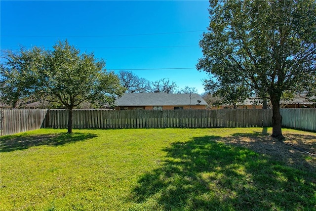 view of yard with a fenced backyard