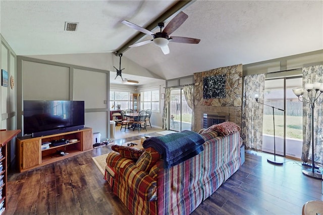 living area with visible vents, vaulted ceiling with beams, a ceiling fan, and wood finished floors