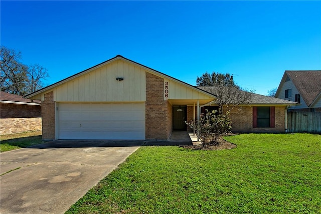 view of front of property featuring driveway, fence, a front yard, a garage, and brick siding