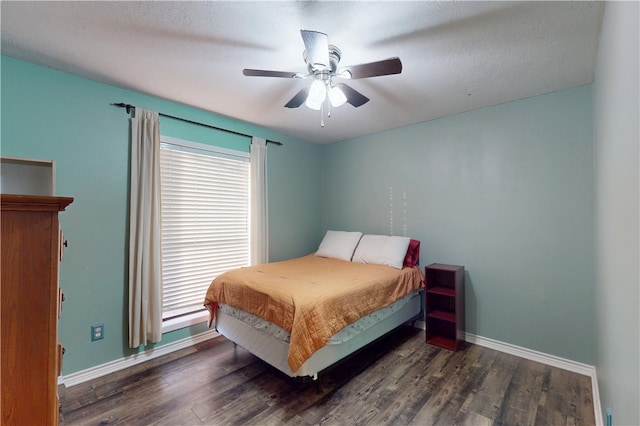 bedroom with a ceiling fan, wood finished floors, and baseboards