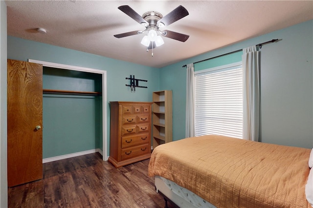 bedroom featuring baseboards, ceiling fan, wood finished floors, a closet, and a textured ceiling